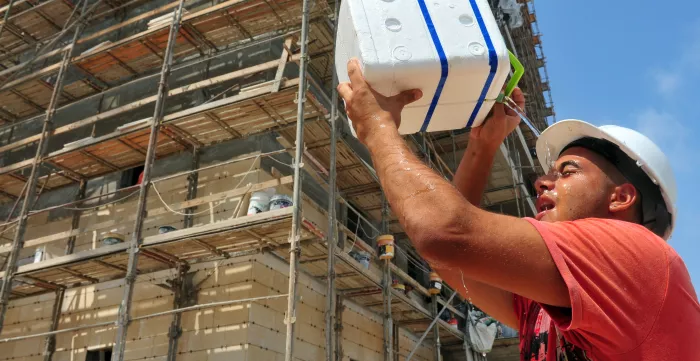 A constuction worker copes with the heat. 