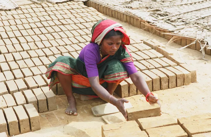 Woman manipulating bricks, Mangalore, India.