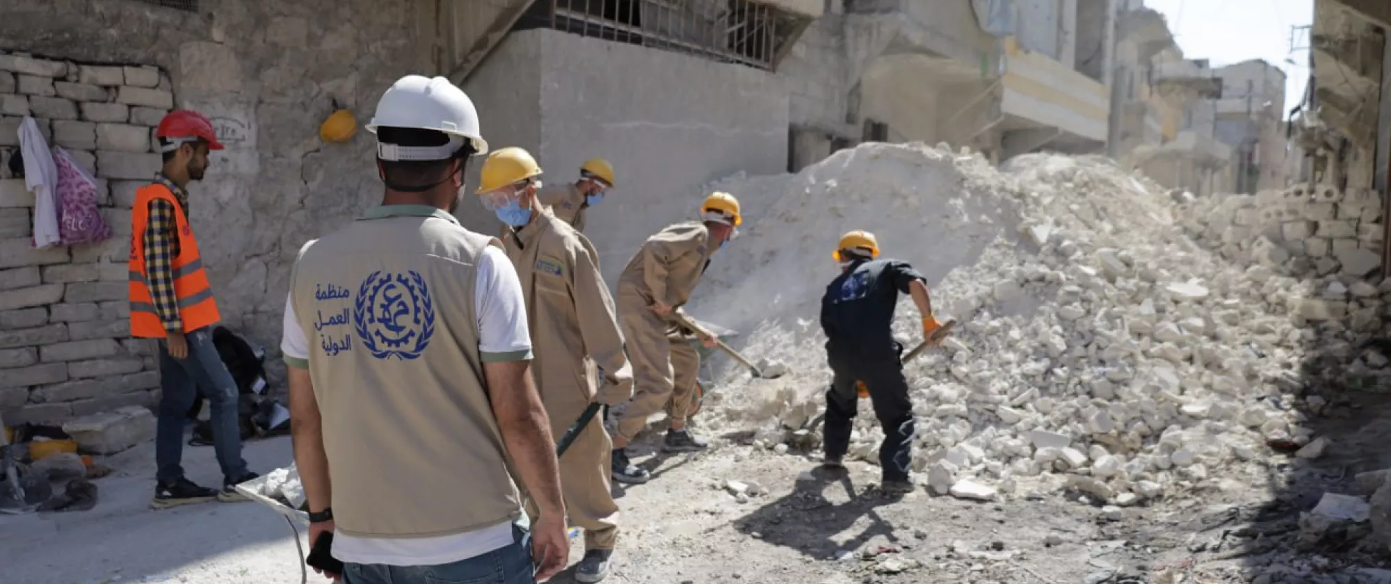 workers removing debris with shovels.