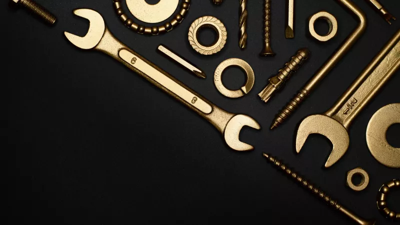 A set of tools placed on a dark background.